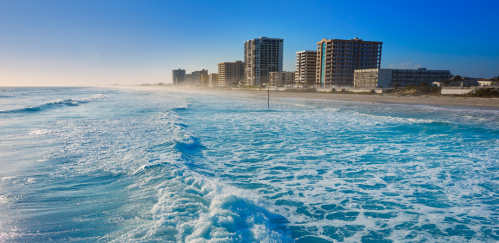 Shore Buildings and wavy beach water at Daytona Beach in Florida.